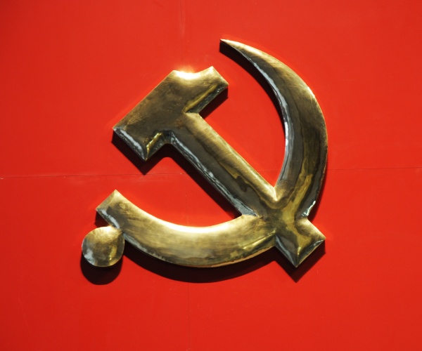 symbol of communist party in gold with red background