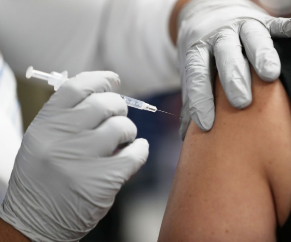  a healthcare worker receives a  covid-19 vaccine 