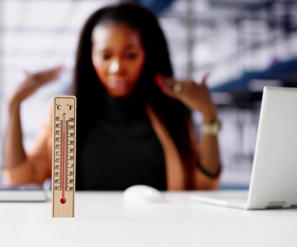 woman working at desk while it is really hot inside