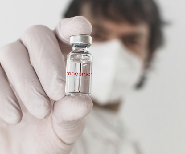 hold up vial of Moderna flu vaccine