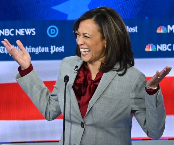 kamala harris laughing and holding up her hands