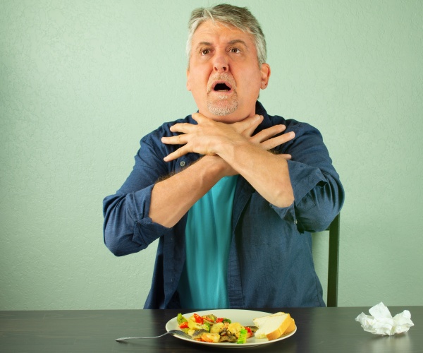 man with hands to throat choking