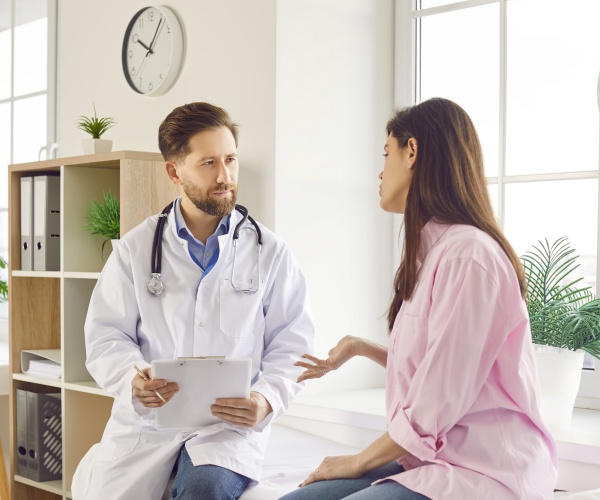 male doctor talking to female patient in office