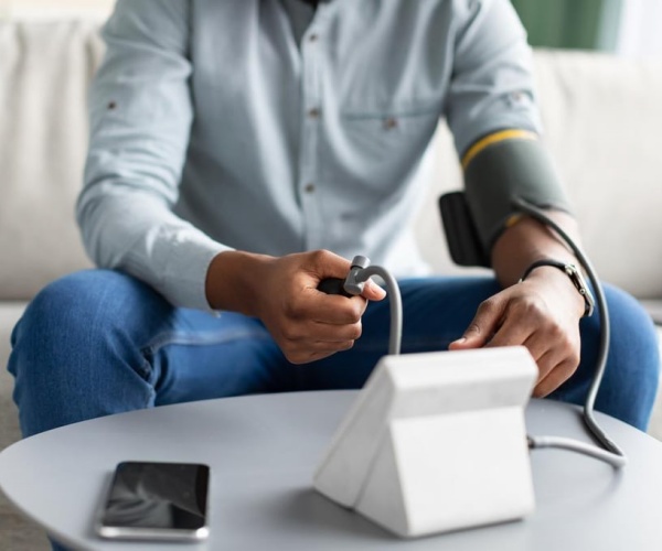 person taking their blood pressure reading at home