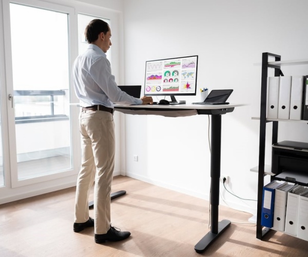 man working at standing desk