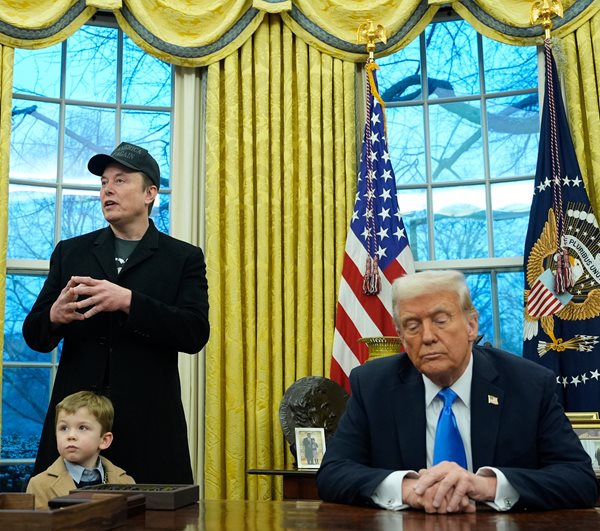 donald trump listens as elon musk speaks in the oval office