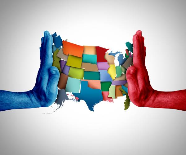 a blue hand and a red hand squish the u.s. map