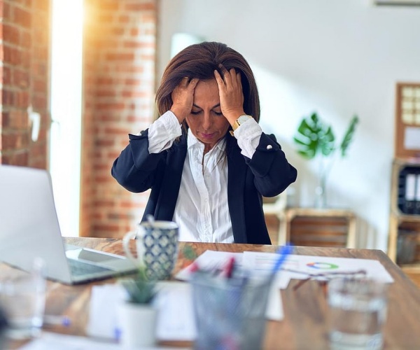 Woman holding her head in pain