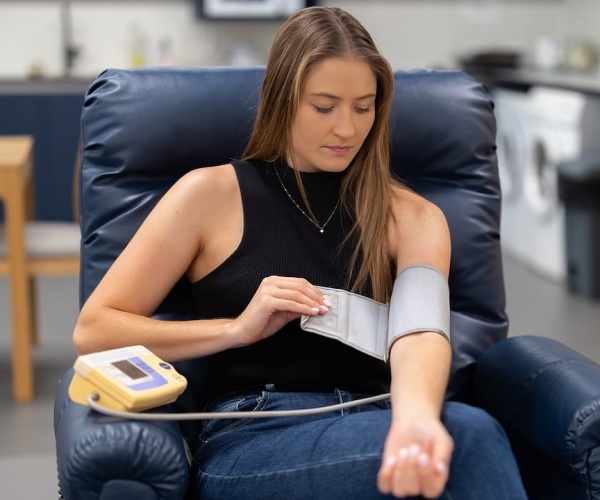 young woman getting blood pressure checked