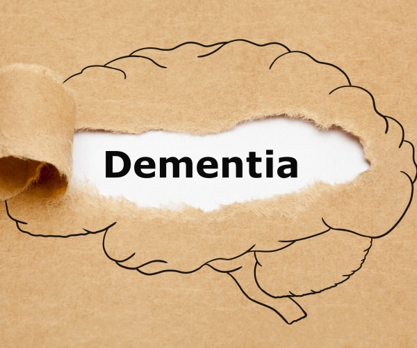 brain illustration on brown paper pulled back with word 'dementia'