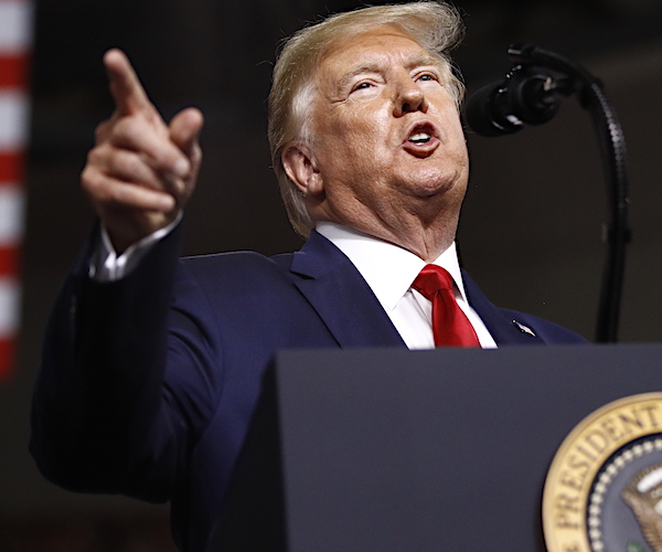 president donald trump points to his right during a campaign rally speech