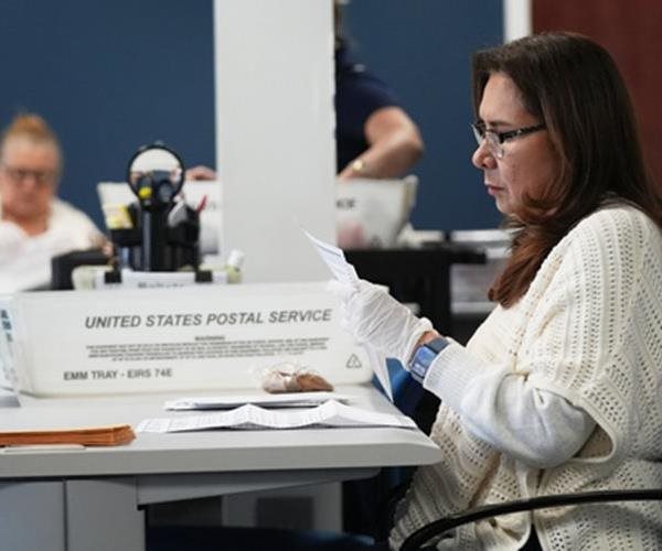 person counting ballots