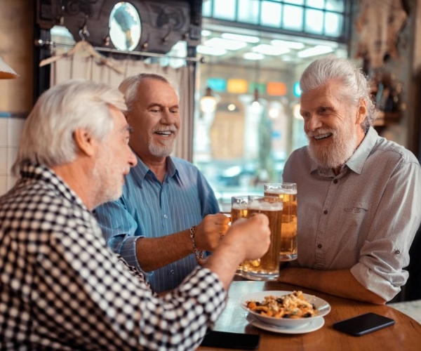 three older men having fun out for dinner and drinks