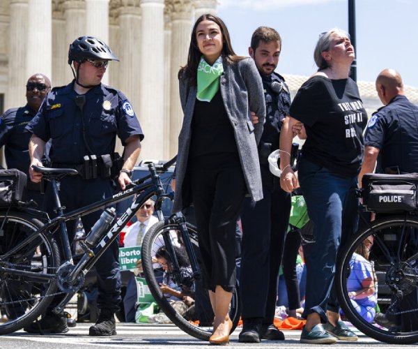 rep. alexandria ocasio-cortez is escorted away from a protest thursday in washington, d.c.