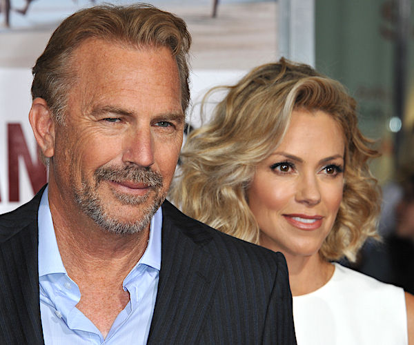 Kevin Costner and wife Christine Baumgartner smile and pose on the red carpet