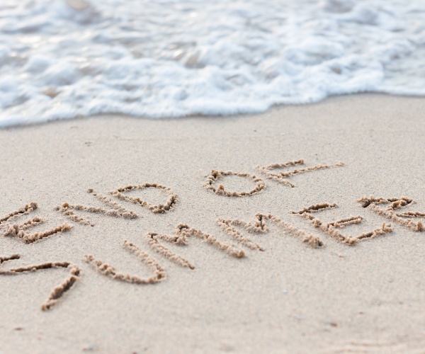 'End of Summer' in sand at beach near water