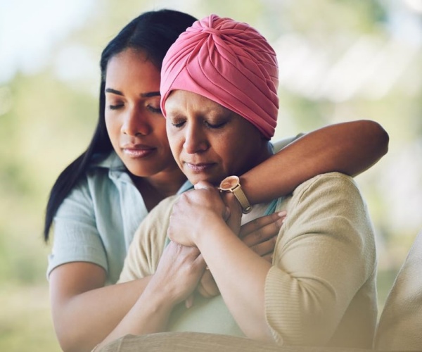 Daughter hugging mother with cancer