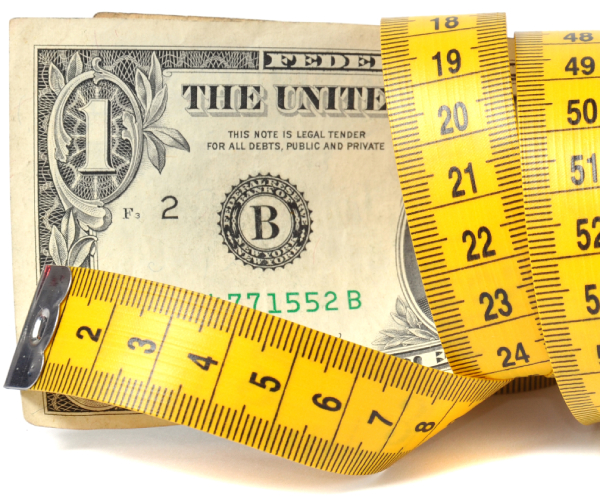 a dollar bill and measuring tape