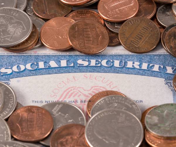 a social security card covered in pennies and other change