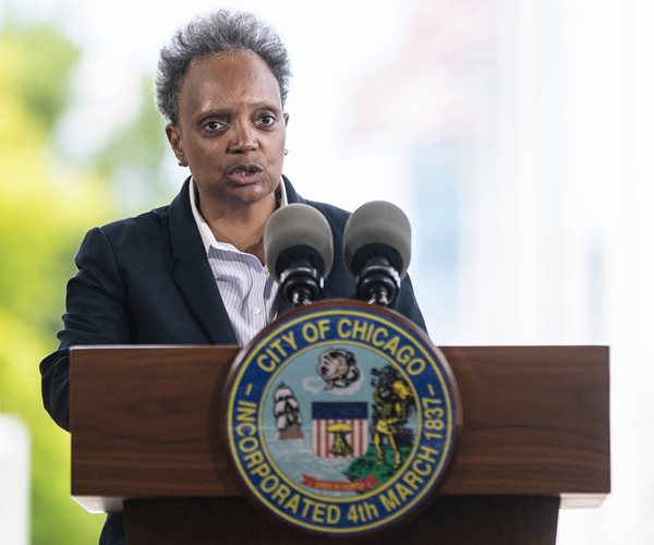 lori lightfoot speaks at a lectern