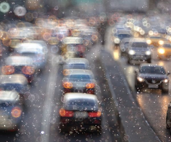 vehicles on a multi-lane highway in bad weather