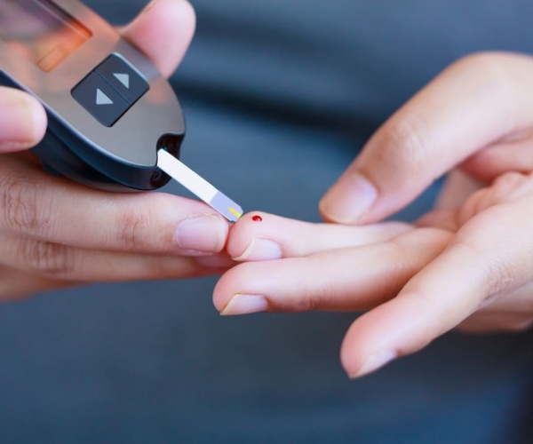 person testing blood sugar