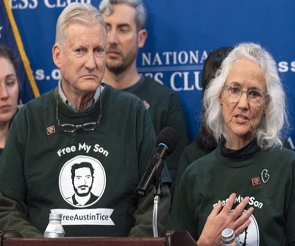 couple speaking from a podium