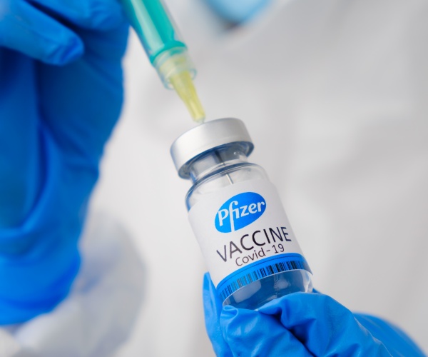 vial of Pfizer COVID vaccine and syringe