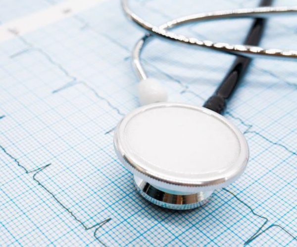 stethoscope on printout of a heart rhythm report