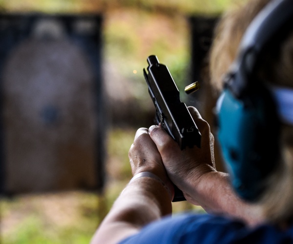 student fires a hand gun