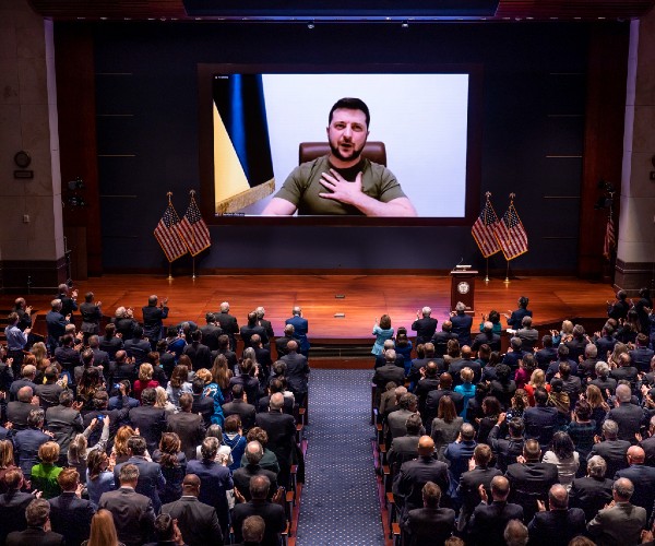 zelenskee on video screen with congress members watching in a theater