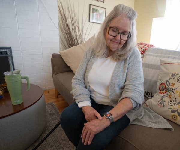 Sue VanWassenhove, a participatn in Ohio State University study, looking at smartwatch on her wrist