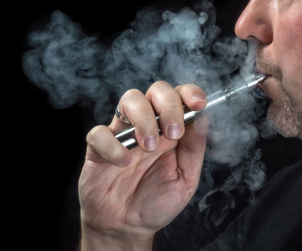 close up of a man vaping