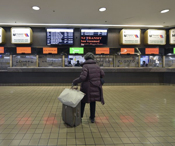 a passenger approaches ticket windows at the port authority bus terminal in new york