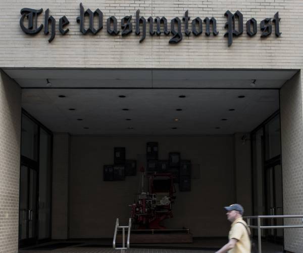 a person walks in front of the washington post office