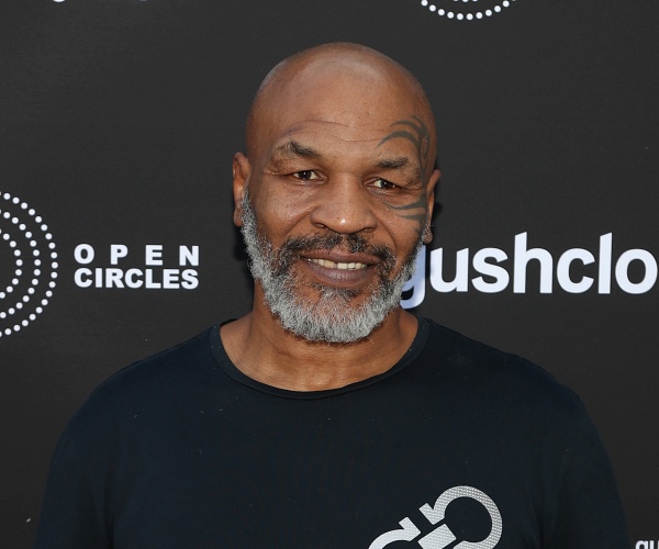 mike tyson stands on red carpet