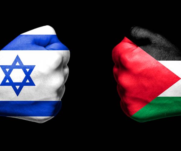 a fist painted like the israeli flag and a fist painted like a hamas flag