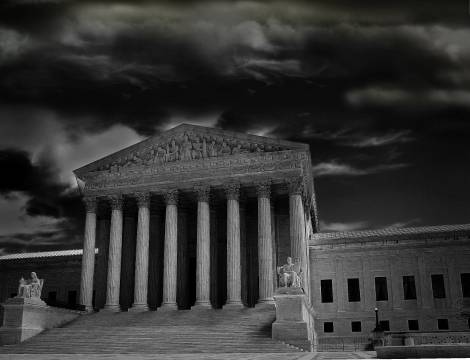 the supreme court building with storm clouds overhead