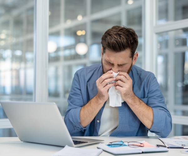 man with a cold at work