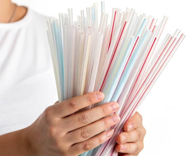 two hands holding a variety of plastic straws