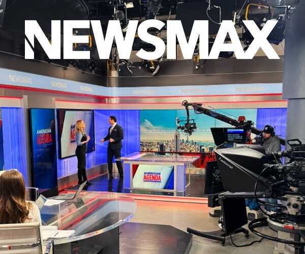 people talking on a newsmax studio set