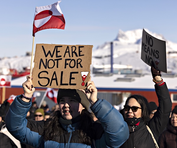 protesters hold signs
