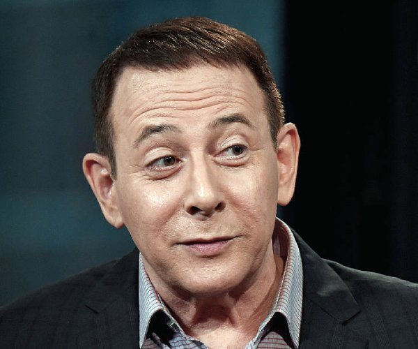 Paul Reubens looks on