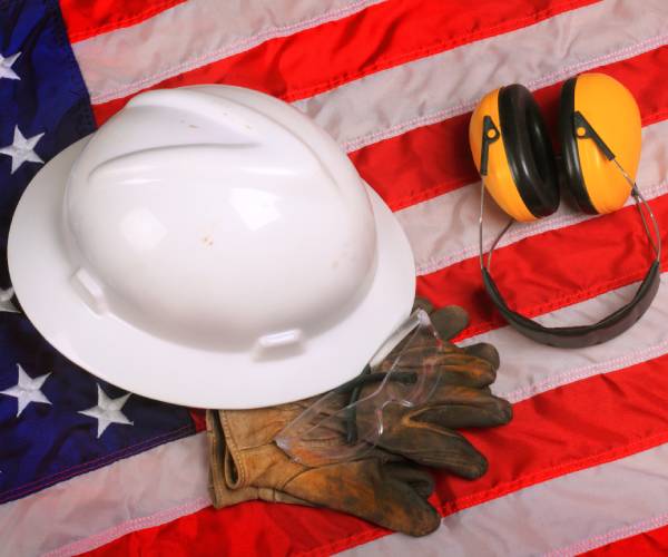 a flag with a safety helmet, goggles, gloves and headphones