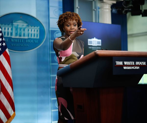 karine jean-pierre in the white house press room behind a podium