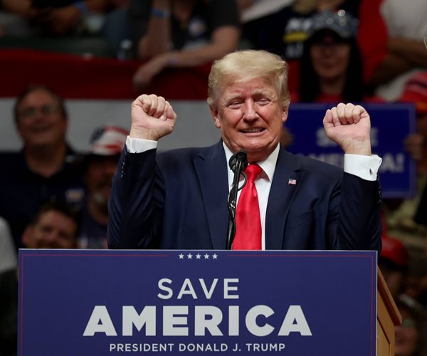 donald trump gestures while speaking behind a podium