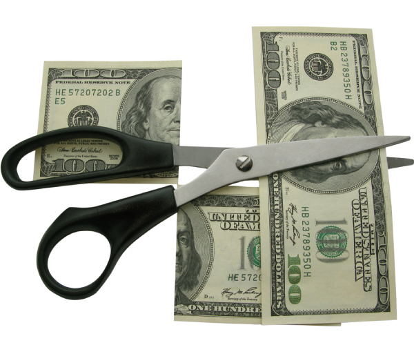 scissors cutting a one hundred dollar bill