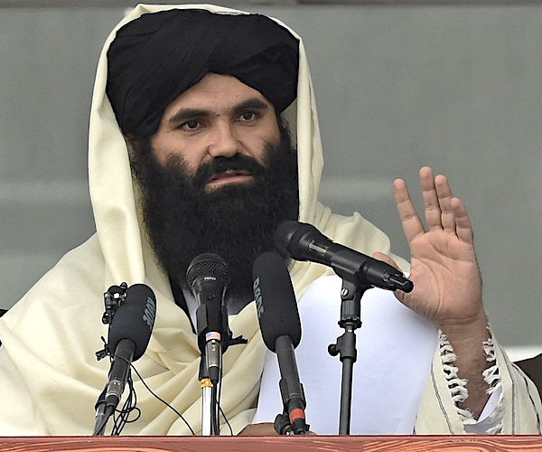 Sirajuddin Haqqani speaks to new Afghan police recruits at the police academy in Kabul, Afghanistan