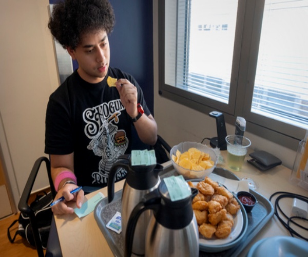 Sam Srisatta, college student eating a meal as part of a study on ultraprocessed foods. 