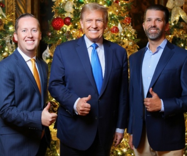 donald trump raising his fist with an american flag backdrop